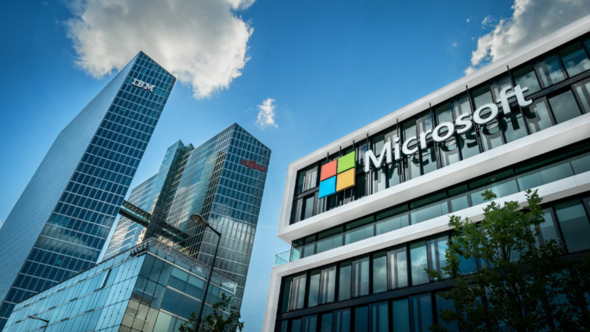 Skyscrapers featuring Microsoft, IBM and Fujitsu logos against a blue sky