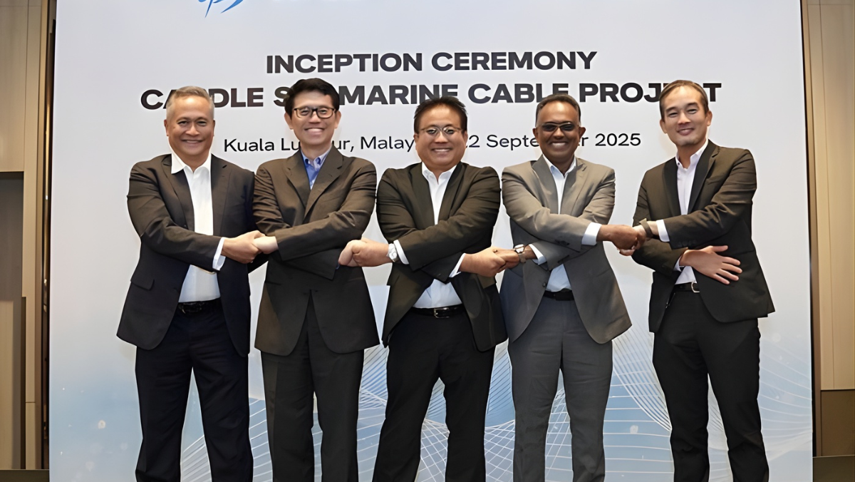 Telecom executives joining hands at a subsea cable project ceremony in Kuala Lumpur.