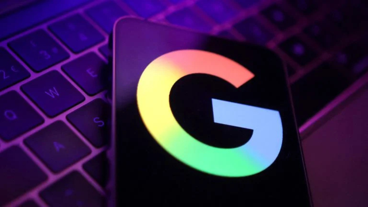 Smartphone showing Google logo glowing on keyboard under purple lighting